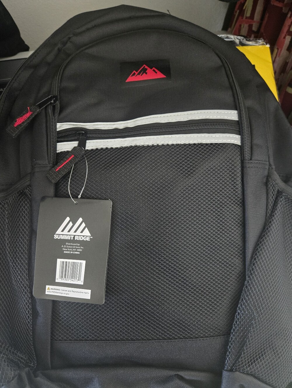 Summit Ridge black backpack with reflective zip binding, rugged polyester fabric